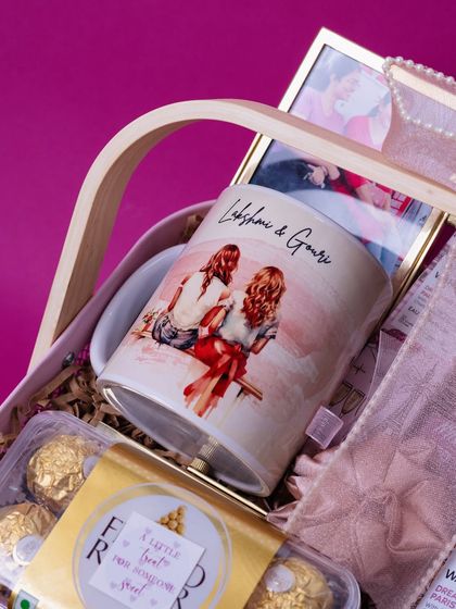 A detail shot of the personalized mug inside the pink and white woven basket, showing the quality of the curation.