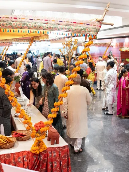 A wide shot of guests mingling and enjoying the food at one of our events. This is what we love to see: a bustling celebration filled with laughter, conversation, and delicious food.