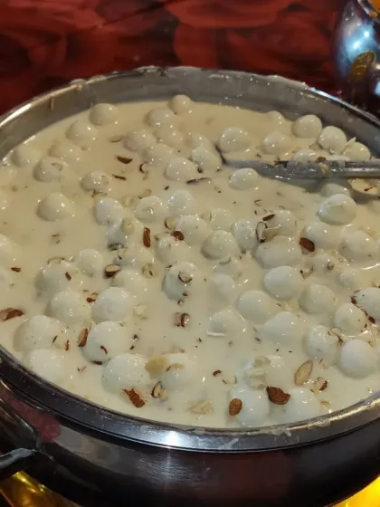 A delightful combination of Rabdi and Rasgulla. This dessert features spongy rasgullas served in a bowl of thick, creamy rabdi, garnished with almonds.