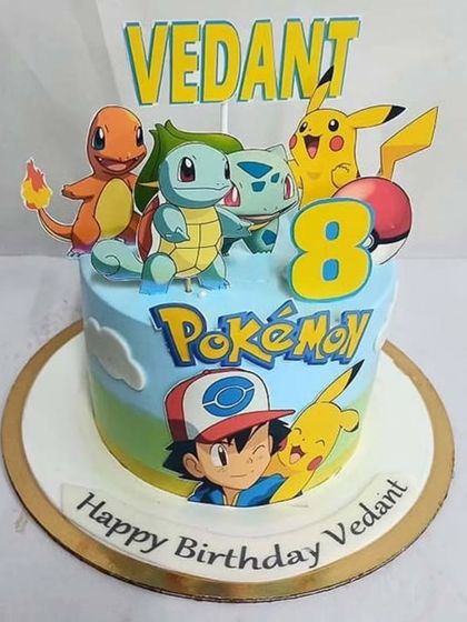 A vibrant Pokémon cake featuring Ash and his team of starter Pokémon. The colorful design and character cutouts are perfect for a young fan's birthday.
