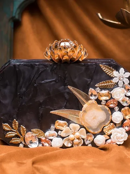This black acrylic clutch is a perfect example of the accessories I offer. It's handcrafted with intricate floral details, agate stone, and rhinestones, adding a touch of luxury to any evening outfit.