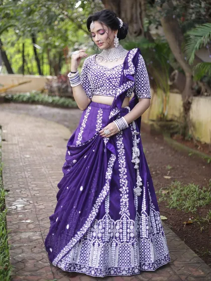 A gorgeous purple lehenga with heavy white embroidery and a pre-draped dupatta. This is a hassle-free, stylish option for any wedding guest or bridesmaid.