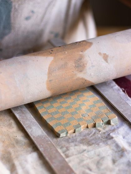 A glimpse into our Nerikomi workshop, showing how colored clay is layered to create a checkerboard pattern. This technique is taught by our resident master, Rajeev.