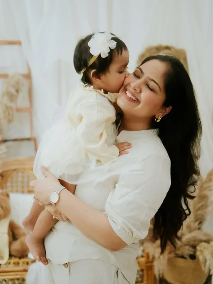 A mother's sweet kiss. This tender moment is a perfect example of the heartfelt memories I aim to create.