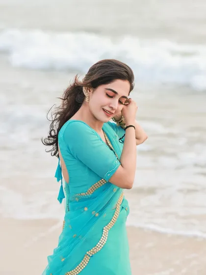 A simple, happy moment by the sea. The soft light and the gentle waves create a serene and beautiful beach portrait.