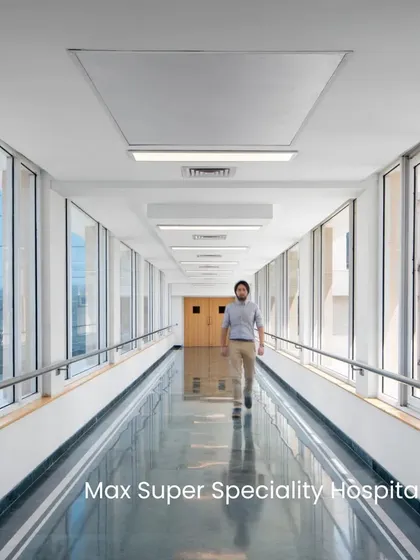 This glass-walled corridor at Max Super Speciality Hospital overlooks the city, providing patients and staff with expansive views and abundant natural light, which is essential for well-being.