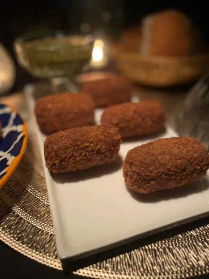 These crispy mutton croquettes are a savory delight. They are perfectly seasoned, breaded, and fried, making for a substantial and delicious appetizer.