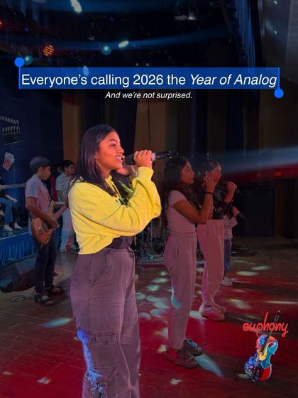 A student vocalist takes the stage during our "Year of Analog" concert. This moment captures the confidence and joy that comes from sharing your voice with a live audience.