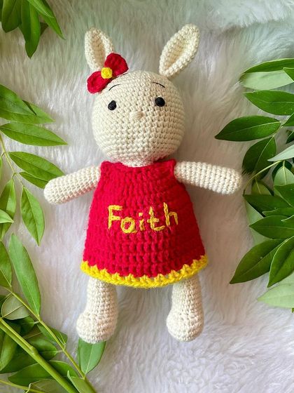 This bunny in a bright red and yellow dress is personalized with the name "Faith". The vibrant colors make her so cheerful and fun.