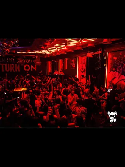 The club is bathed in red light, with the crowd fully immersed in the music. These are the nights I live for.