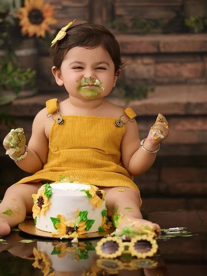 The aftermath of a fun sunflower cake smash. We make sure to capture every angle of the joyful mess, from frosting-covered fingers to happy smiles.
