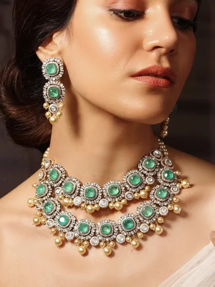 A double-layered emerald and pearl necklace, offering a classic and sophisticated look for any grand celebration.