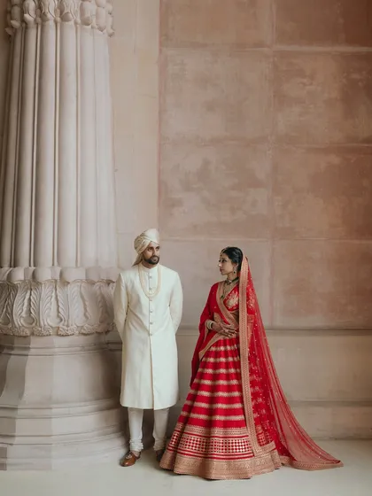 Avin and Nikki stand as modern royalty at The Leela Palace in Bangalore. This image showcases the grandeur and elegance I aim to capture in large scale, luxury Indian weddings.