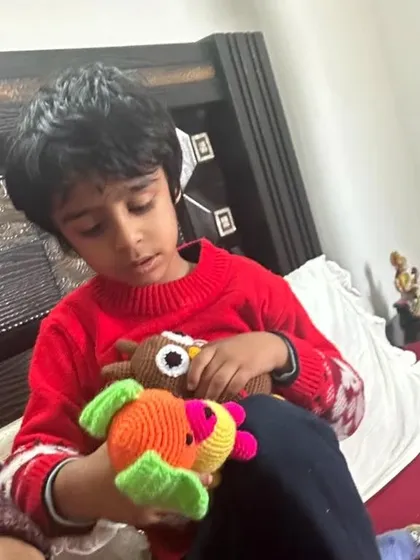 The little boy looking closely at his new handmade toys.