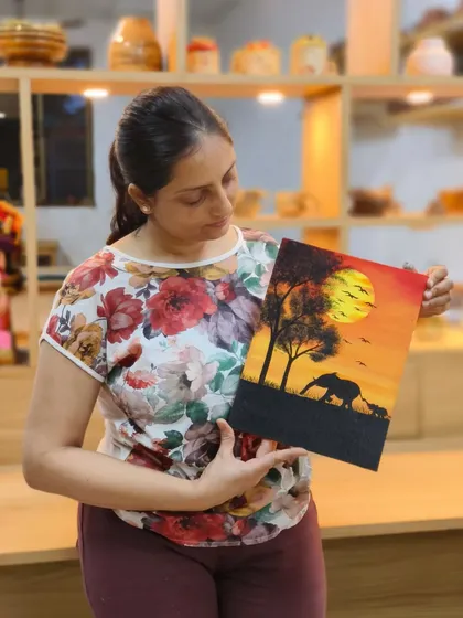 Priyanka holds her finished elephant canvas. Our courses encourage students to explore their own creative ideas, guiding them from concept to a beautiful final artwork.