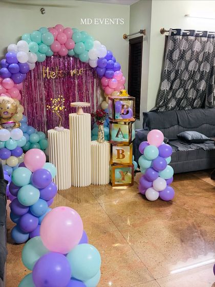 A side view of the pastel "Welcome Baby" setup, highlighting the shimmer backdrop and the 'BABY' blocks filled with colorful papers.