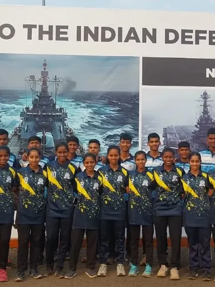 Our young athletes during the Dervan state-level competition, standing before a banner saluting the Indian Defence Forces.