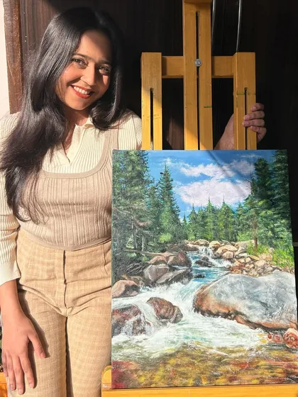 Here I am with my finished oil painting of a flowing river in a forest. This 20x16 inch canvas captures the unstoppable force and beauty of nature.