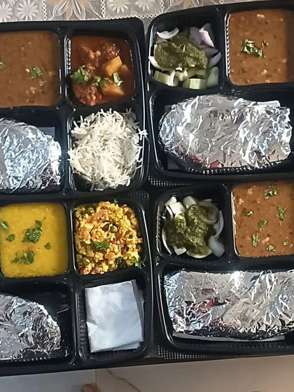 This image shows the variety I offer in a single day. One thali has kofta curry and dal makhni, while the other has paneer bhurji and yellow dal, catering to different tastes.
