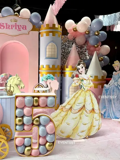 This angle showcases the large, balloon-filled number '5' and character cutouts of Belle and Cinderella, adding a personalized touch to the princess theme.