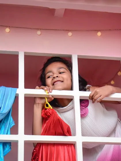 A happy smile peeking out from the window of our playhouse. There are so many corners to explore.