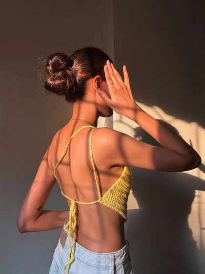 The back view of my yellow halter top, showing the adjustable lace-up detail. You can tie it as tight or as loose as you like for a custom fit.