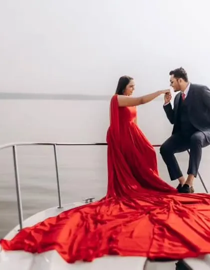 For a touch of glamour and romance, you can’t go wrong with a classic red gown. This infinity trail gown looks incredible on a yacht, creating those luxurious, cinematic shots you've always wanted.