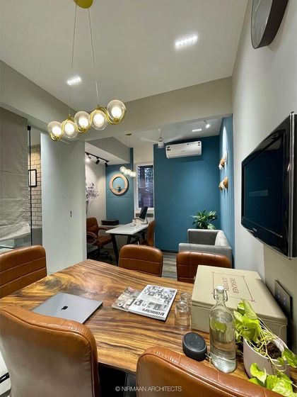 A view of our conference room, with its live-edge wooden table and a bold blue accent wall. It's a professional yet inspiring environment for our client meetings and team discussions.