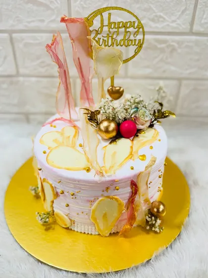An abstract and artistic birthday cake with a watercolor effect and delicate, translucent sugar sails. A unique and modern design for any art lover.