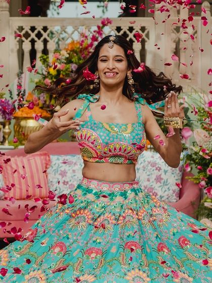 A vibrant bridal solo with a flower petal shower. The bride's colorful lehenga and the joyful choreography made this Mehendi performance a visual treat.