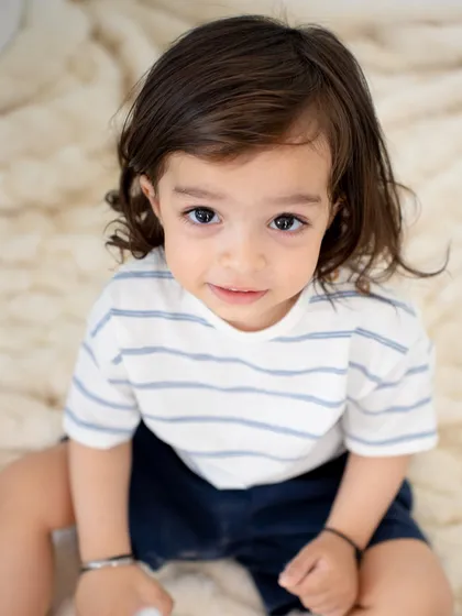 A soulful and direct look from this sweet toddler. A simple, clean background allows his beautiful eyes to be the star of the show.