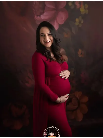 The pregnancy glow is real, and this beautiful mom-to-be is proof. A rich color like this red gown against a soft, floral backdrop creates such a warm and joyful feeling. My goal is to capture your happiness in these simple, beautiful moments.