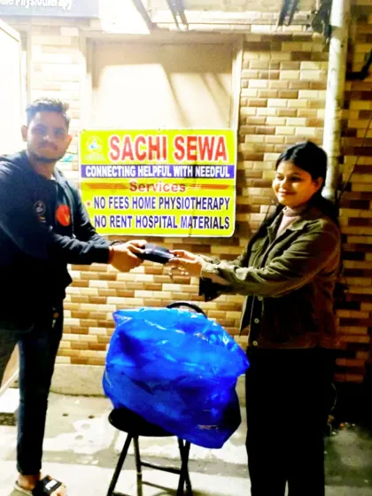 A young man receives a warm muffler from our team. Every donation is a personal gesture of care from our community to our community.