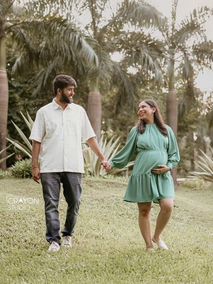 Walking hand in hand through a green park, this couple shares a smile. I love capturing these simple, moving moments that tell the story of their journey together.