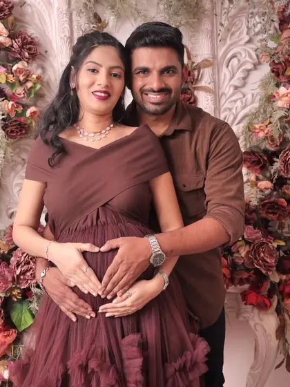 A classic and tender moment between the expecting parents. We focus on capturing the love and connection you share as you wait for your little one's arrival. This heart pose is a favorite for many couples.
