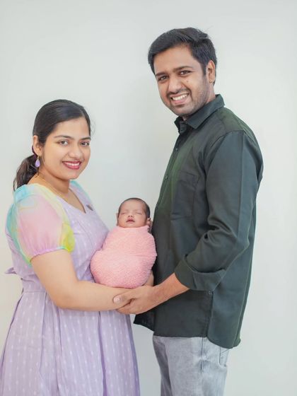 A timeless family photo that is perfect for announcements and framing. The simple composition and genuine smiles make this a treasured keepsake.