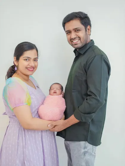 A timeless family photo that is perfect for announcements and framing. The simple composition and genuine smiles make this a treasured keepsake.