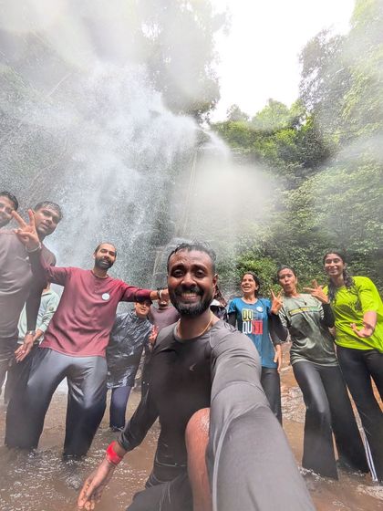 A trek lead takes a selfie with the group, all soaked and happy, at Hidlumane Falls.