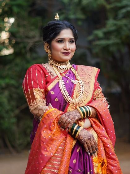 A close-up of a stunning Maharashtrian bride in a traditional Peshwai Nauvari saree. The look is completed with classic jewelry and bold, defined makeup.