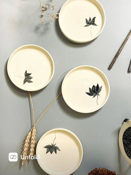 My Lotus Dessert Plates, seen here arranged as wall art, are now available on my website. They are perfect for serving sweets or as a stunning decorative piece for a nature-inspired vibe.