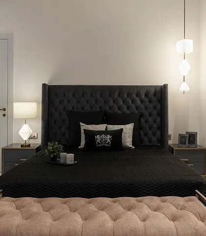 A teenage boy's retreat, featuring our custom bed with a dramatic, tall, button-tufted headboard in black, paired with a contrasting pink tufted bench.