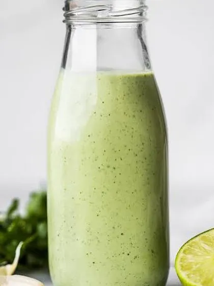 My Creamy Cilantro Lime dressing, bottled and ready. It's a fresh and zesty dressing made with cilantro, lime, and garlic, perfect for salads or as a dip.