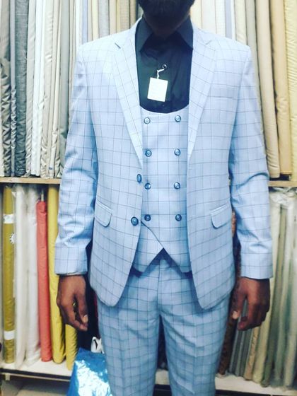 A client looking sharp in a light blue checked three piece suit I tailored for him. You can see how the suit is fitted to his frame, a result that only comes from custom measurement and stitching.
