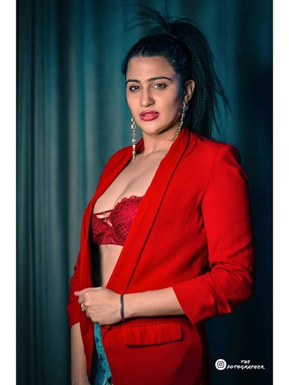 A bold and confident studio look with a striking red blazer. This type of powerful styling is great for building a strong and memorable modeling portfolio.