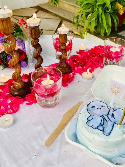 A close-up of the adorable custom cake and the warm, flickering candles that create a magical ambiance.