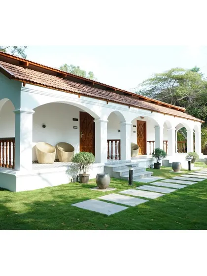 I design verandas that truly extend your living space into the outdoors. The series of whitewashed arches and a terracotta-tiled roof offer a nod to traditional design, providing a shaded, comfortable area for relaxation. The seamless transition to the lawn via stone pathways encourages an indoor-outdoor lifestyle.