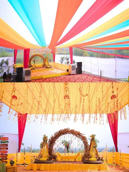 The stage and canopy for a Haldi carnival, featuring vibrant drapes and a rustic pampas grass arch.