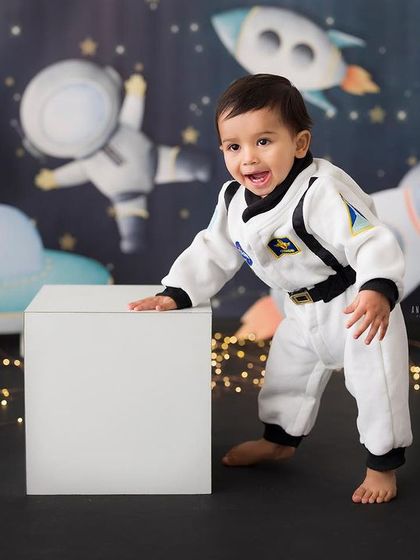 One small step for a baby, one giant leap for fun! This little astronaut is ready for an adventure in our space-themed setup, perfect for a creative first birthday.