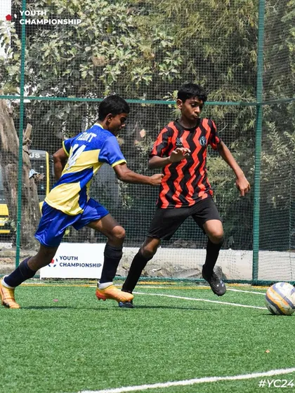 A young player on the dribble, taking on a defender during a Youth Championship match. We encourage our players to be confident on the ball.