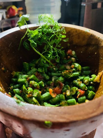 Making a snake bean chutney in my mortar. I've added fresh king chilli, roasted tomatoes, garlic, roasted dried fish, and fresh coriander.